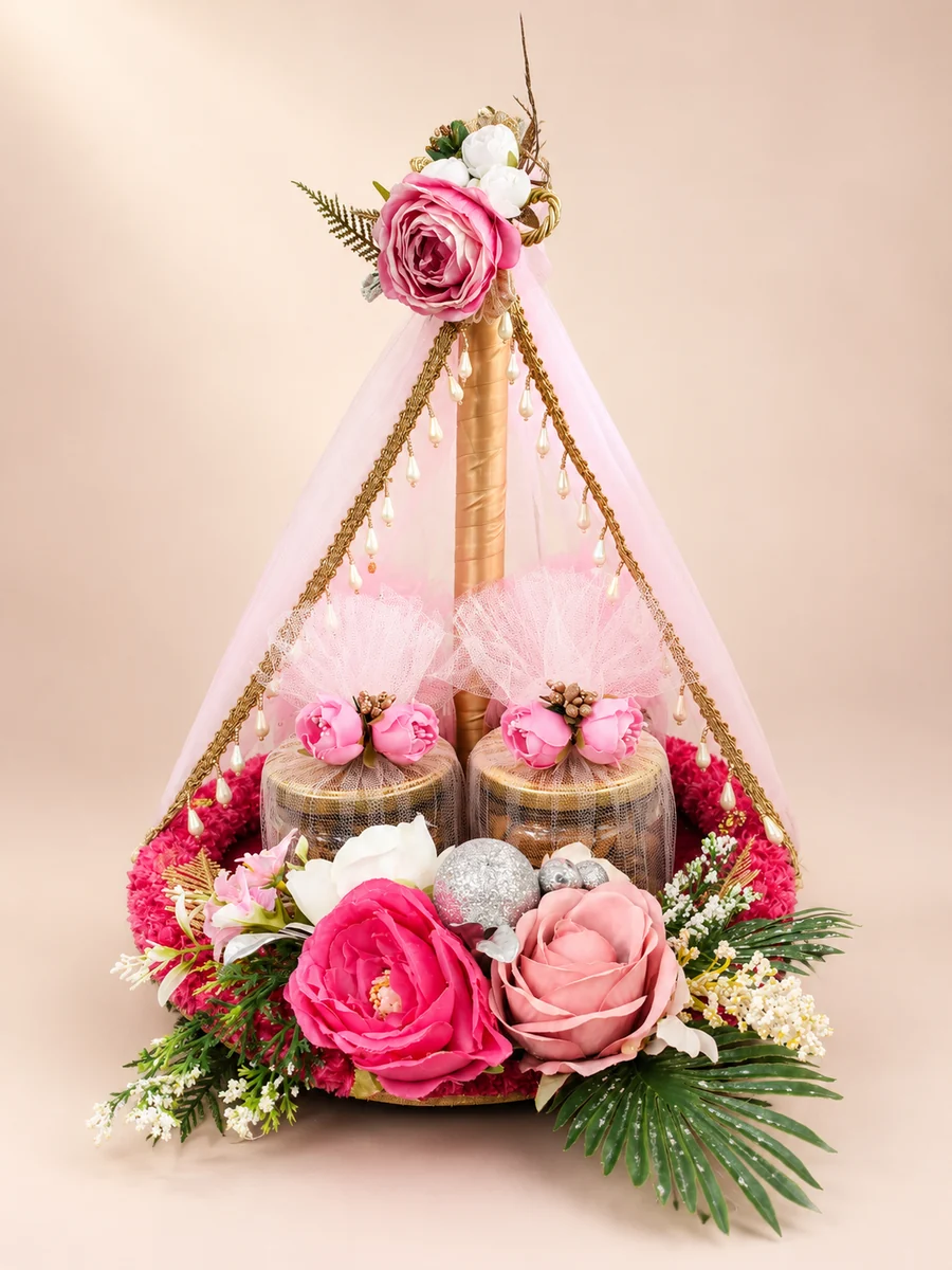 A handcrafted pink Badi Beti hamper filled with gifts, flowers and pearl details
